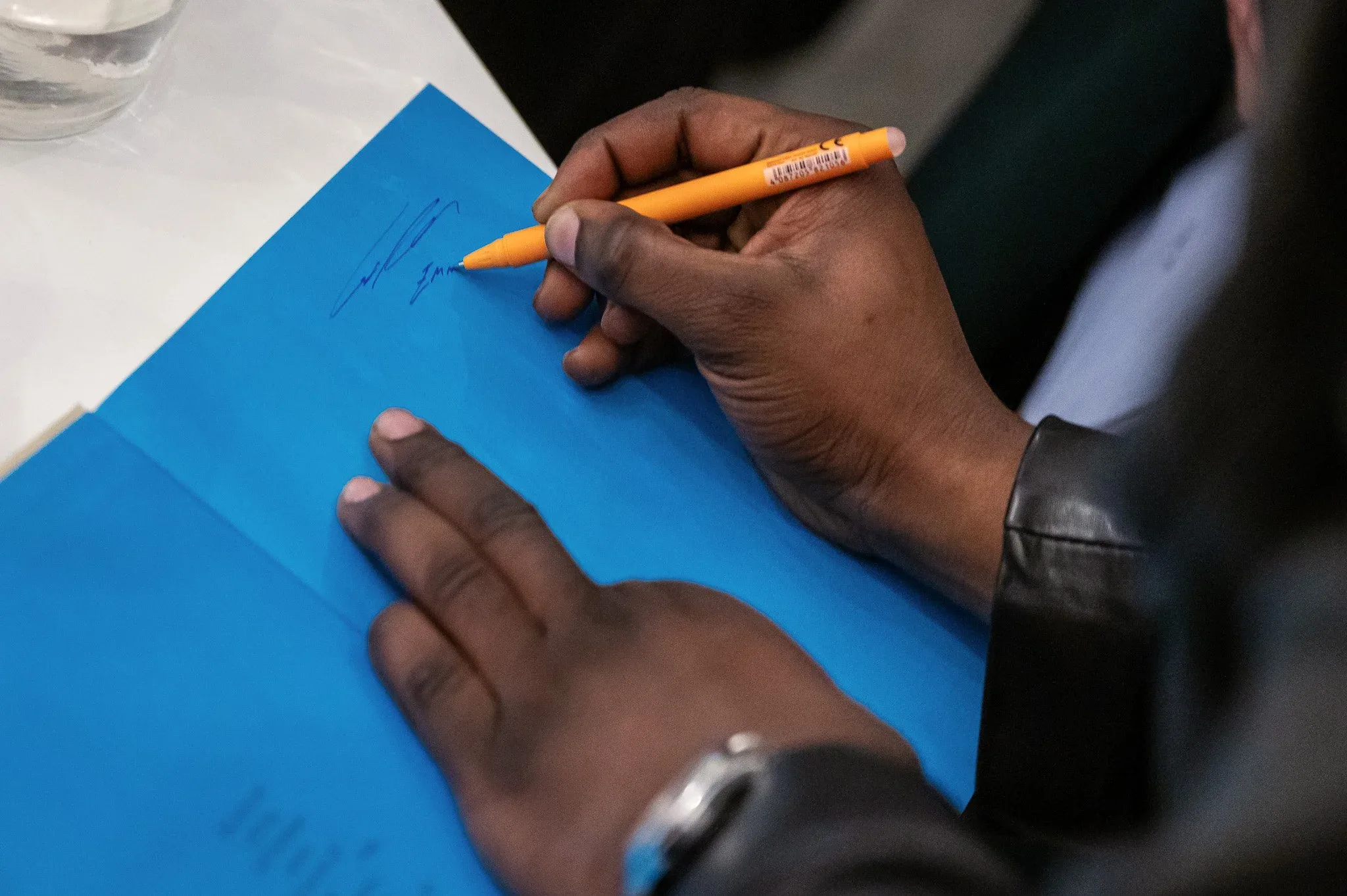 Eric Asamoah signing one of his books