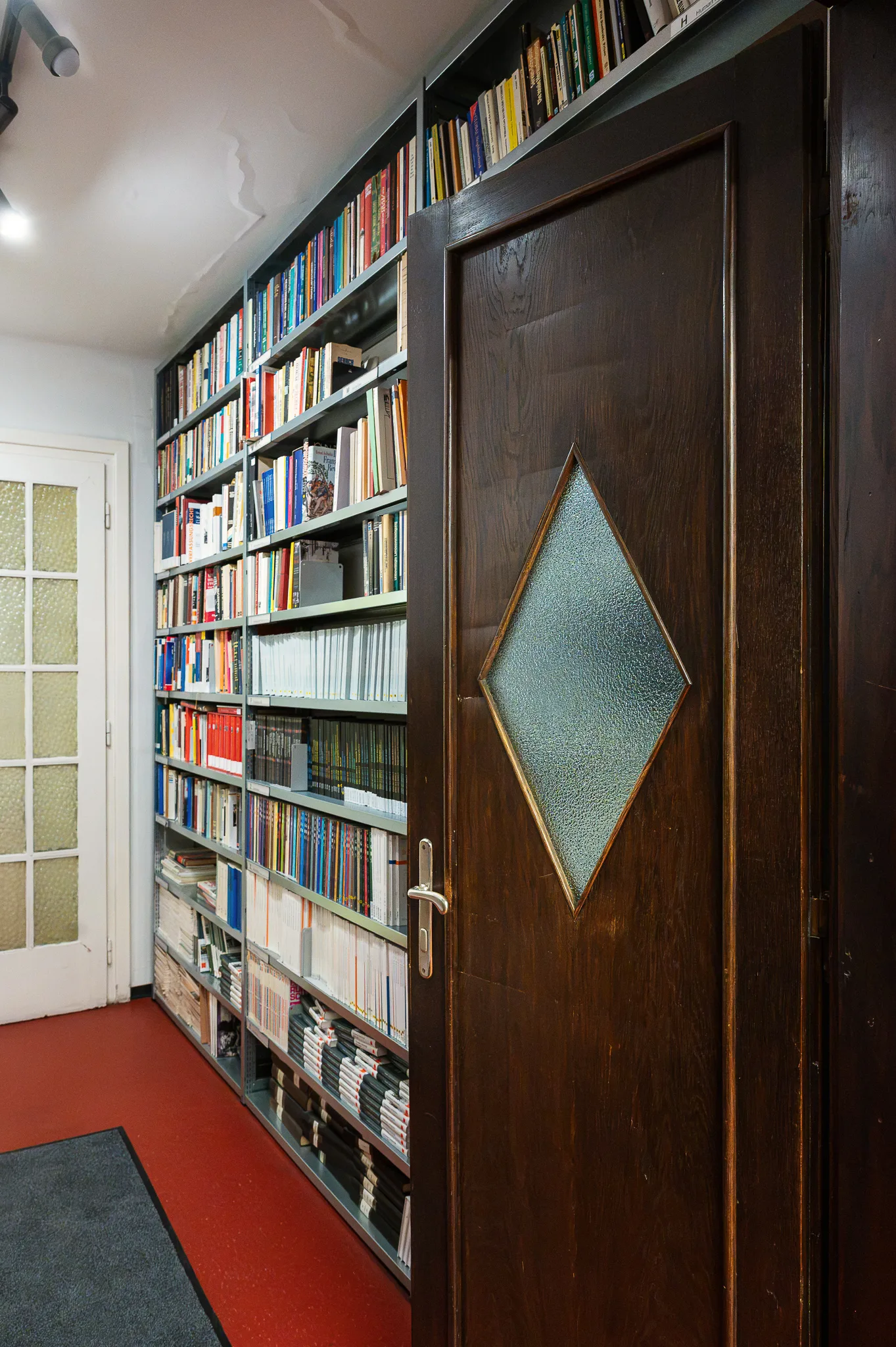 Bookshelves and a door with a diamond-shaped window, Bruno Kreisky Archive, Vienna, 2026
