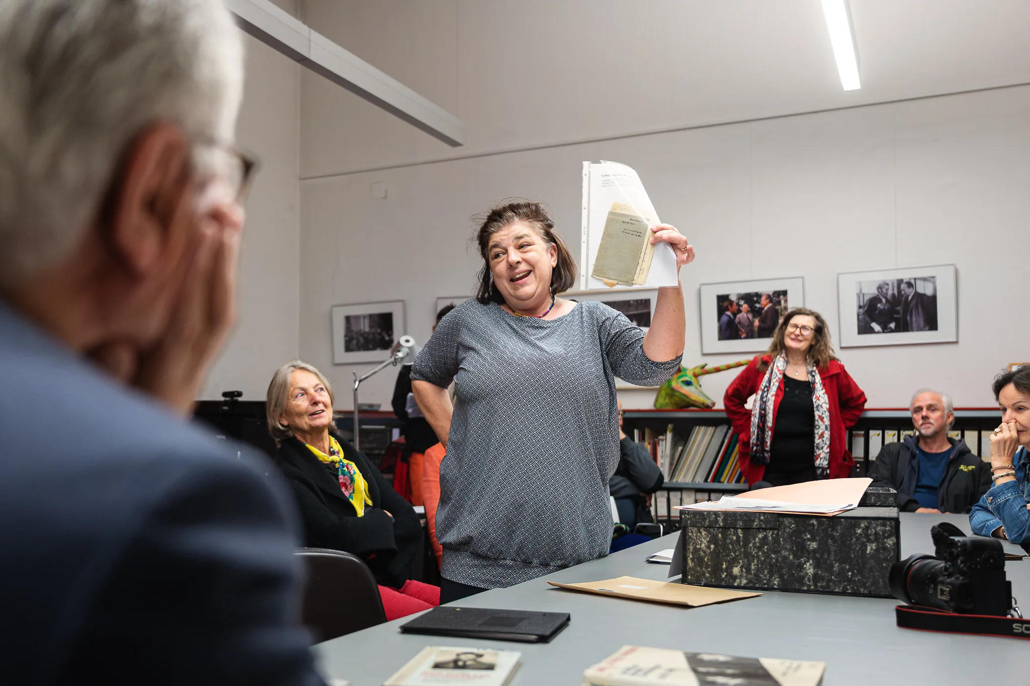 Maria Steiner holding up a document from the collections, Bruno Kreisky Archive, Vienna, 2026